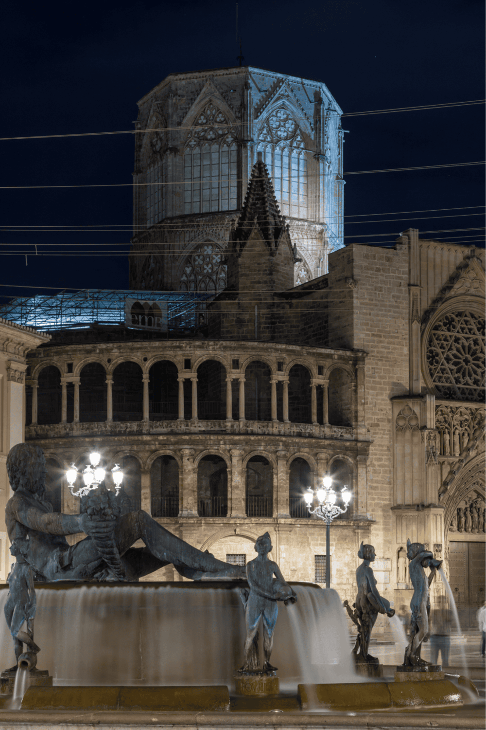 Night view of the historic Cathedral of Murcia with illuminated fountain in the foreground.