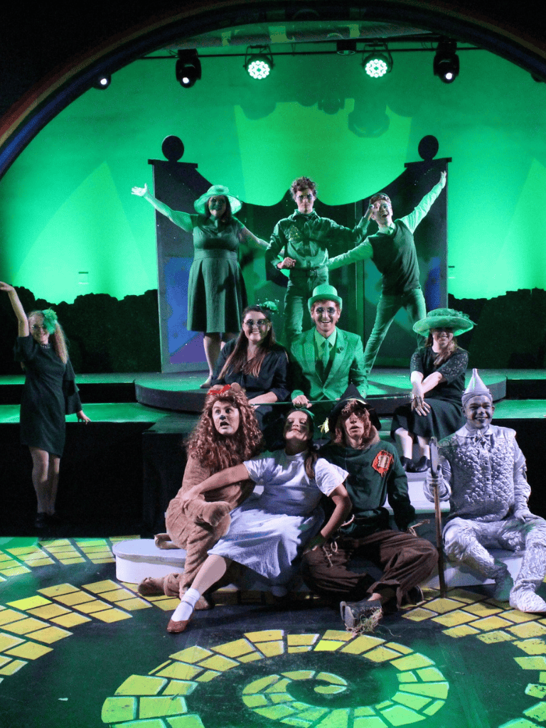 Whimsical stage play performance featuring colorful costumes and theatrical set design for entertainment.