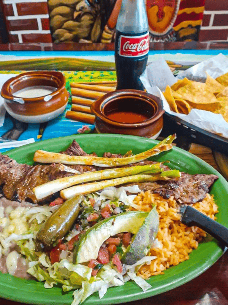 Savory Mexican dinner with grilled meats, rice, and fresh salsa at a local restaurant.
