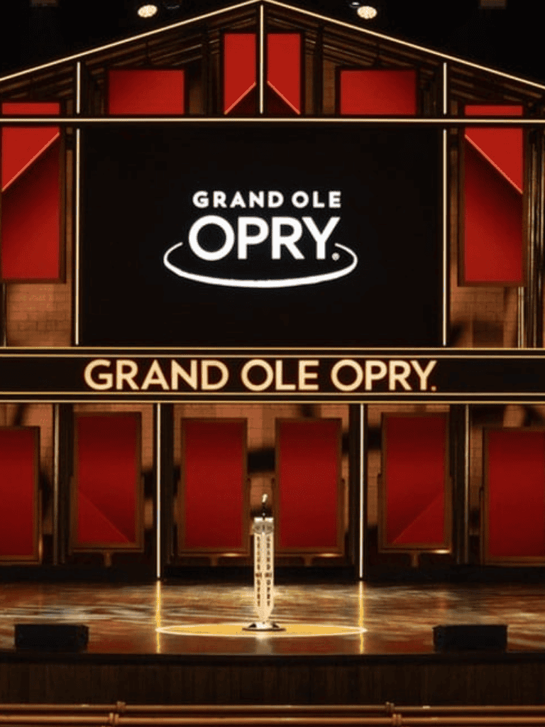 Elegant Grand Ole Opry stage with illuminated signage showcasing Nashville's iconic music venue.