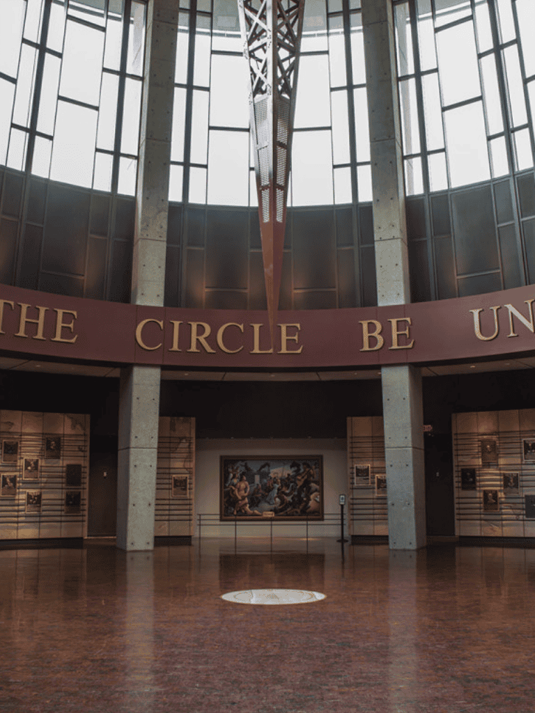 Vast museum interior with modern architecture and famous artwork displayed.