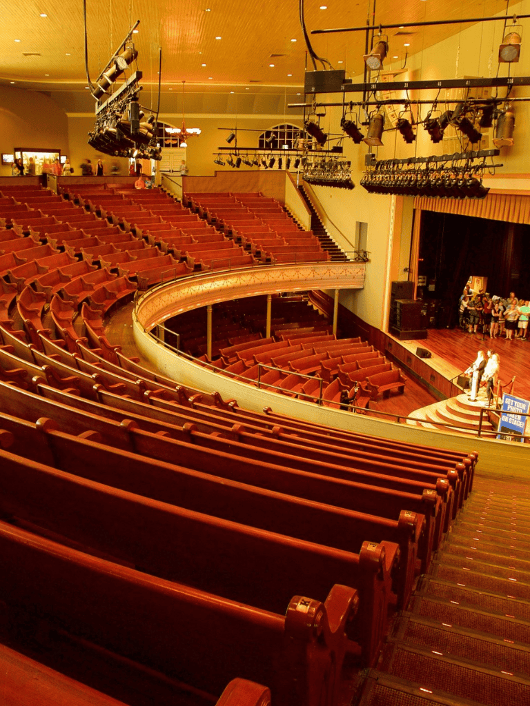Orchestra seats and stage at Quest for Directions theater, showcasing seating arrangement and stage setup.