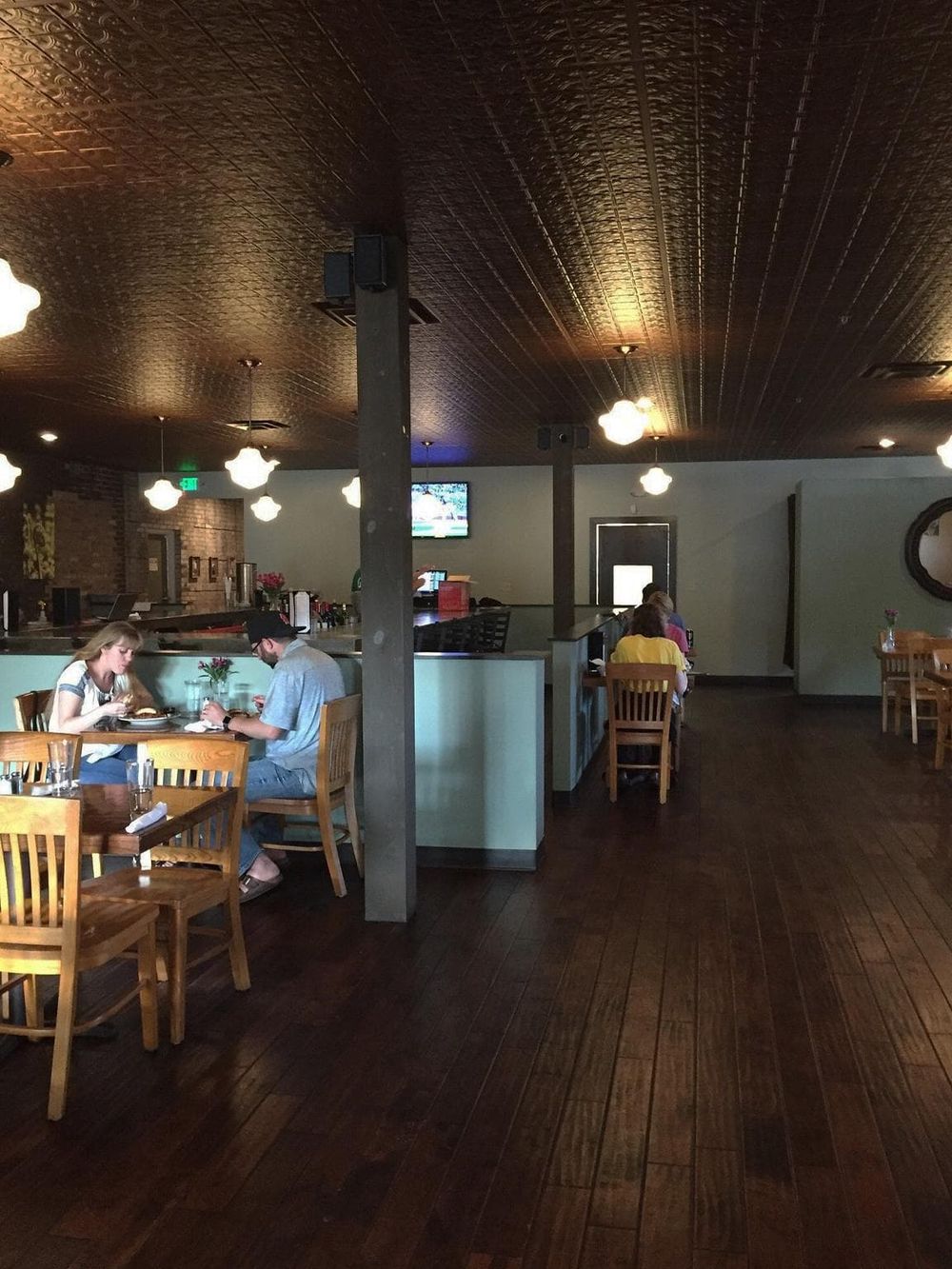 Cozy restaurant interior with wooden furniture and warm lighting for a relaxing dining experience.