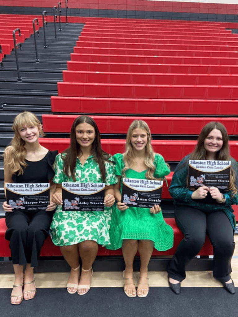 Academic achievement recognition at Sikeston High School in a stadium seating area.