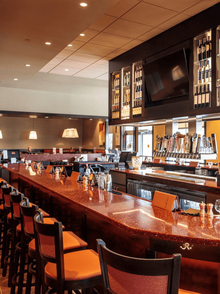 Luxurious bar interior with wine display and modern decor for upscale dining experiences.