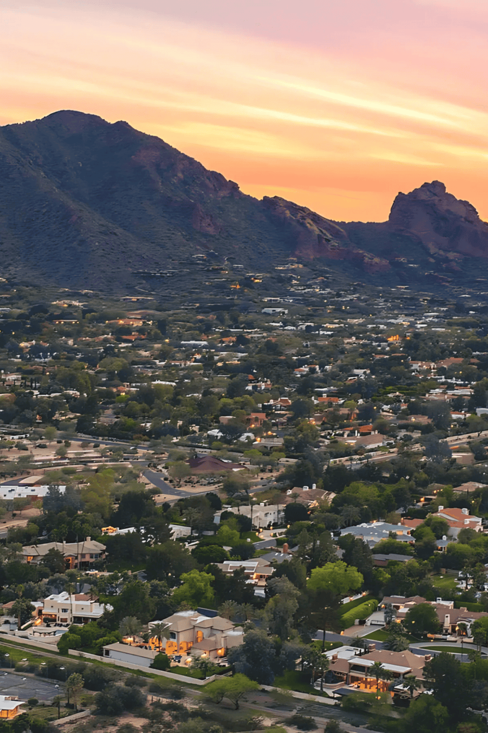 Mountain view and cityscape in Scottsdale, Arizona at sunset, showcasing suburban neighborhoods and scenic natural landscape.