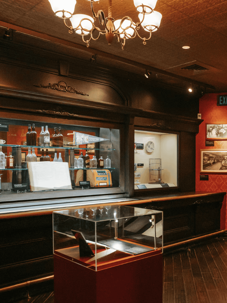 Vintage liquor display case in a luxurious bar setting.