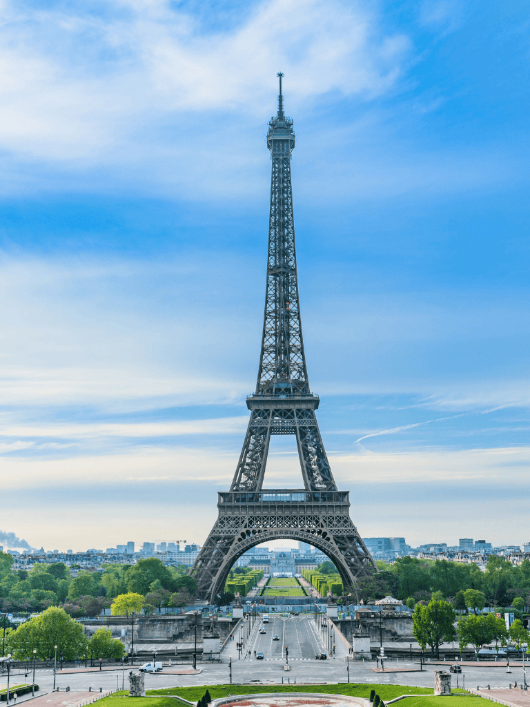 Ancient Eiffel Tower in Paris France, with clear blue sky, iconic landmark and popular tourist attraction.
