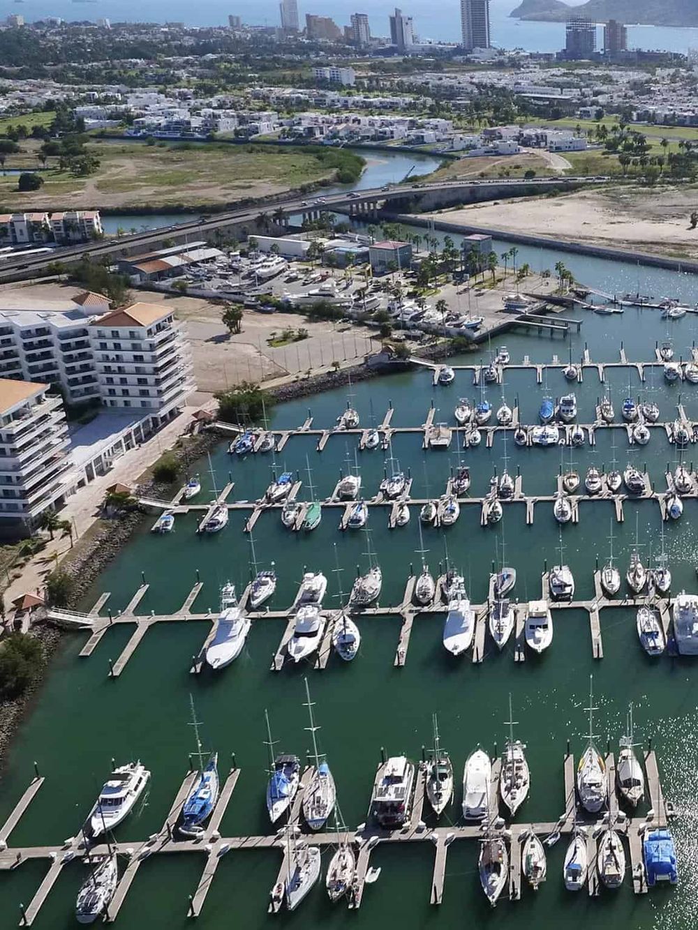 Marina with yachts in downtownQuestForDirections, scenic harbor with boats, and city skyline for travel and navigation.
