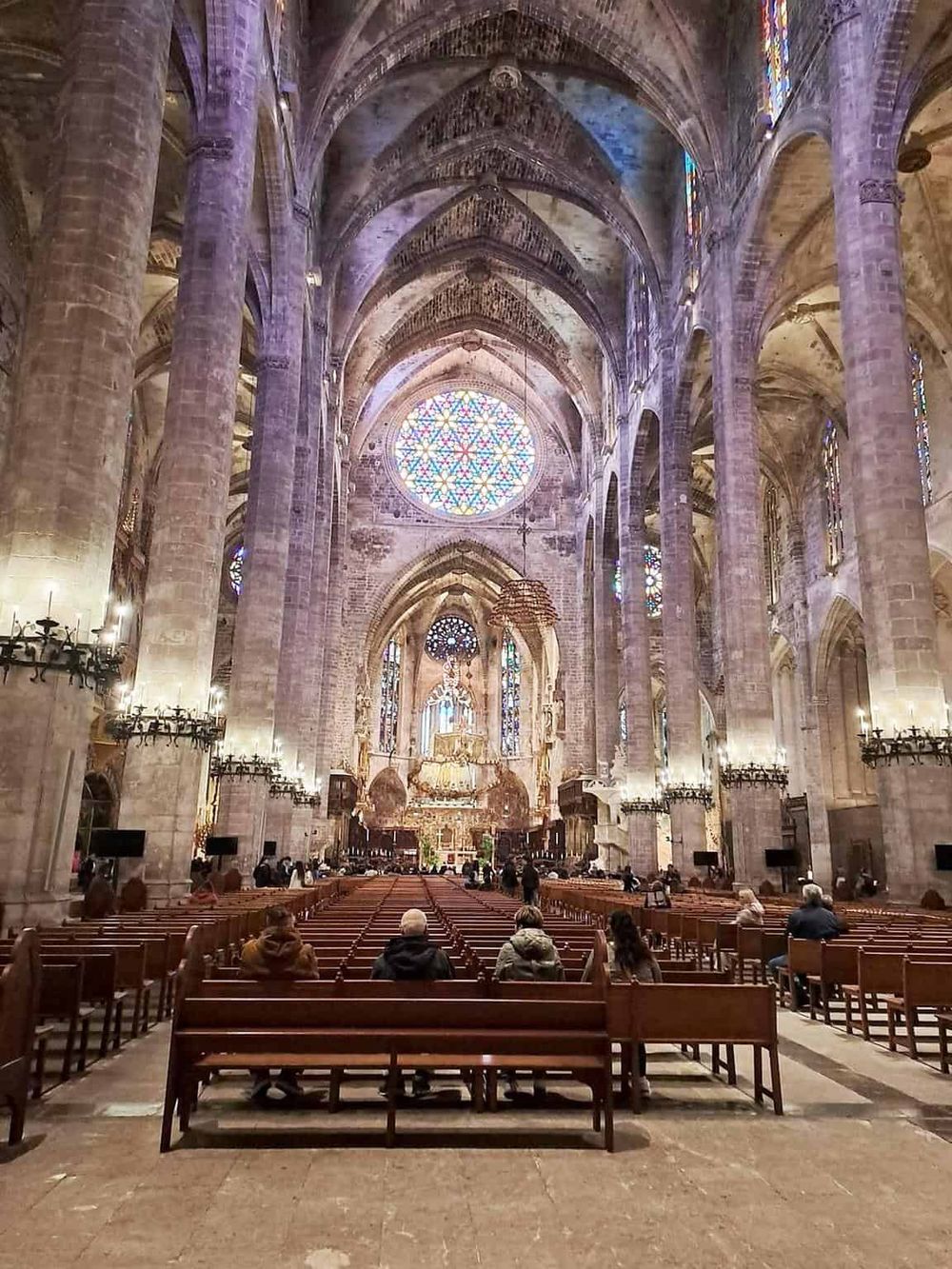 Stunning interior of a historic cathedral with soaring ceilings, stained glass windows, and intricate architecture.