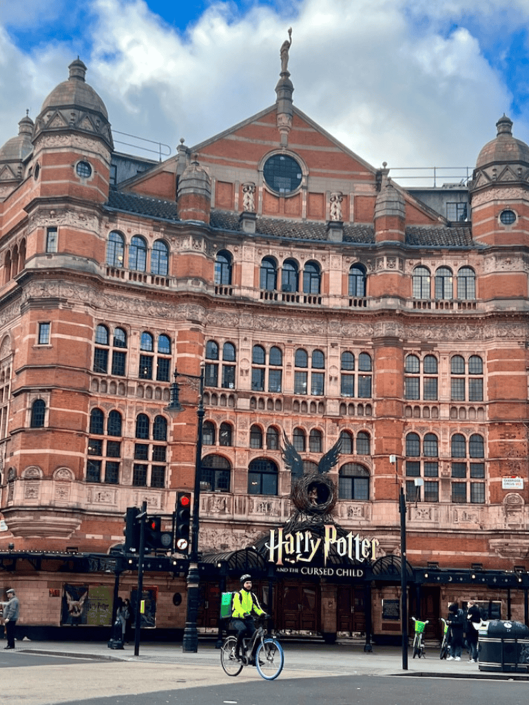 Bright red brick Harry Potter store at London’s Kings Cross Station, offering magical merchandise and immersive experiences.