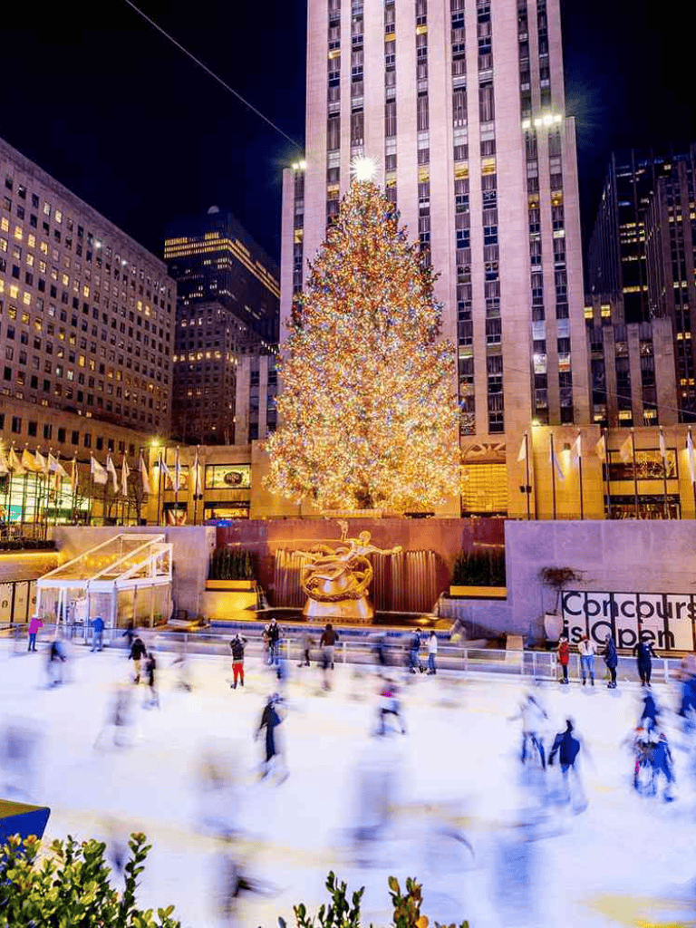 Decorated Christmas tree in Rockefeller Center during winter night, New York City.