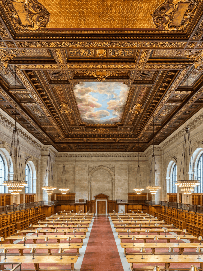 Majestic historic library with ornate ceiling and large arched windows, ideal for learning and research.