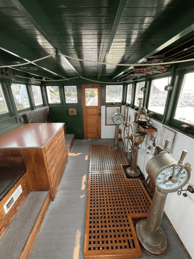 Vintage boat interior with navigational tools and wooden accents for maritime navigation.