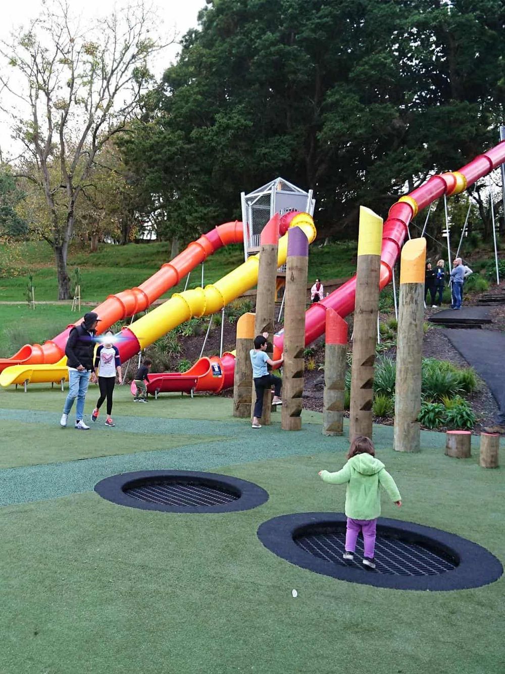 Colorful outdoor playground with slides and trampolines for kids' fun and recreation.