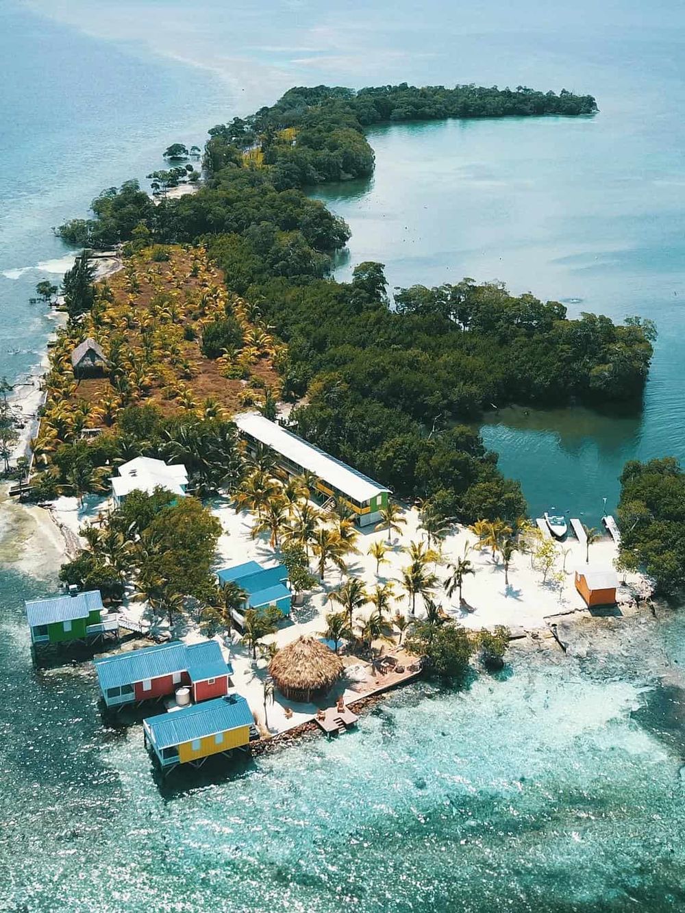 Secluded tropical island with vibrant overwater bungalows and lush greenery, perfect for eco-friendly travel.