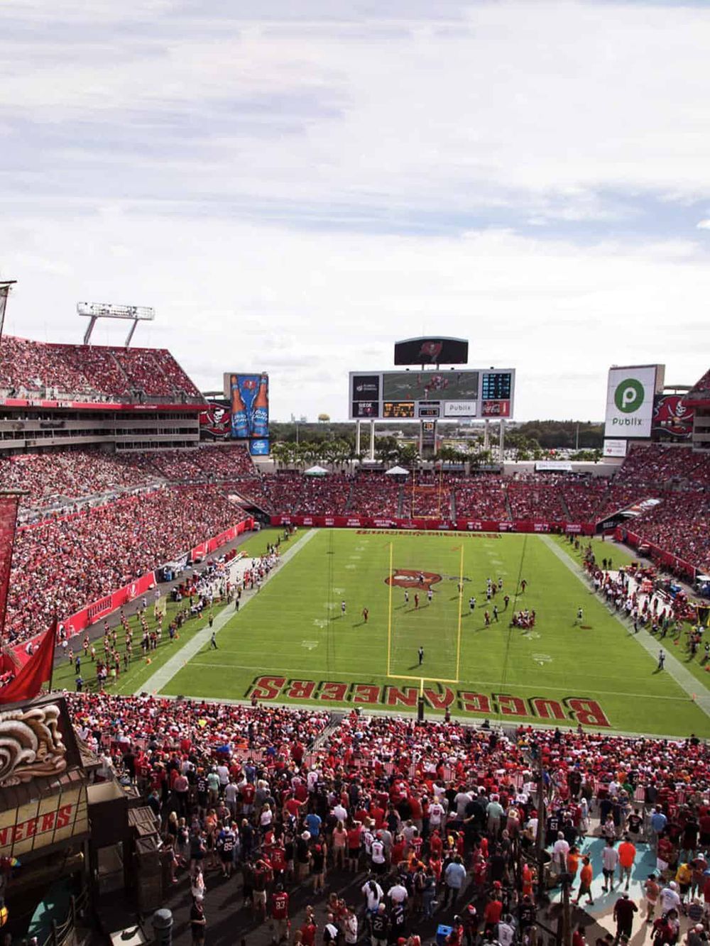 Vibrant Tampa Bay Buccaneers football game at Raymond James Stadium with passionate fans and lively atmosphere.
