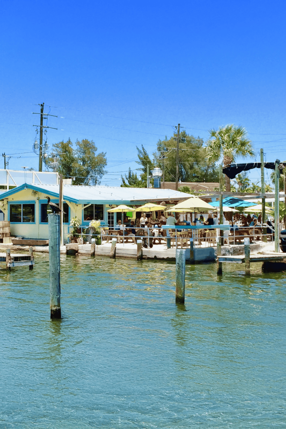 Sunny waterfront dining at Quest for Directions, a top restaurant with outdoor seating and scenic views.