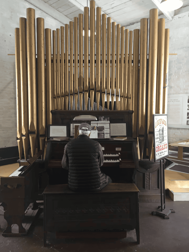 Pipe organ performance at historic church, showcasing traditional musical instruments for visitors.