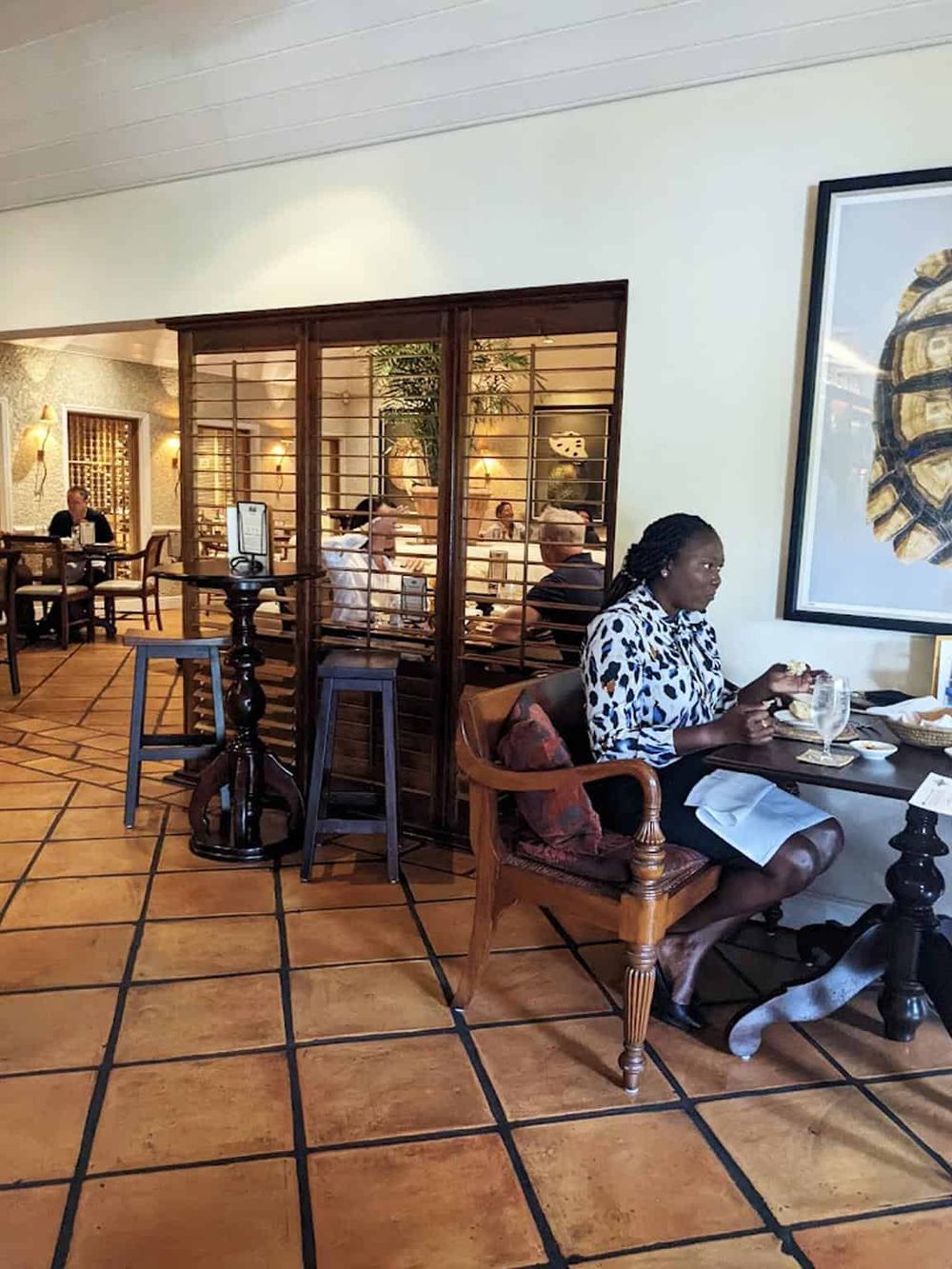 Quiet restaurant interior with diners, stylish decor, and a cozy atmosphere.