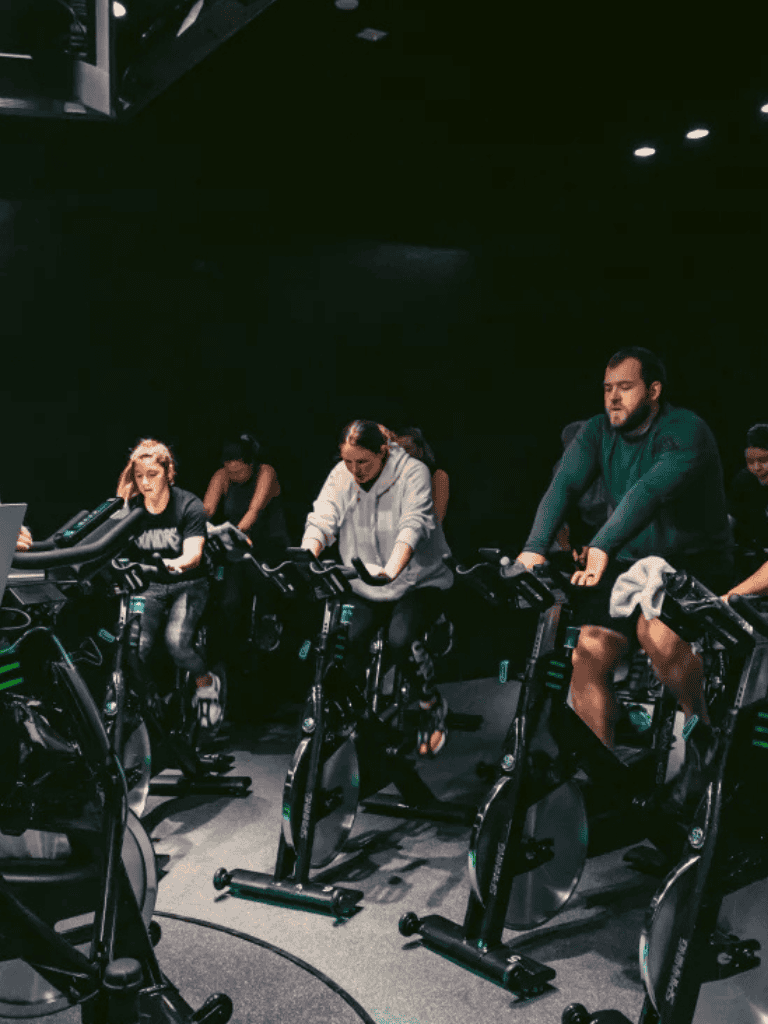 Indoor cycling class at QuestForDirections fitness center.