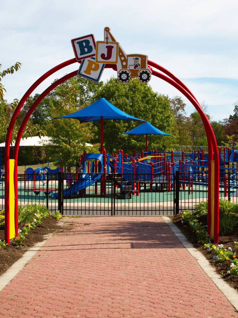 Bright children's playground at QuestForDirections with colorful play structures and shade umbrellas, perfect for outdoor fun and exploration.