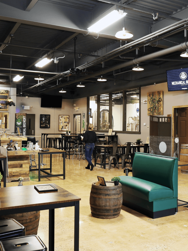 Craft brewery interior with modern industrial design and cozy seating areas.