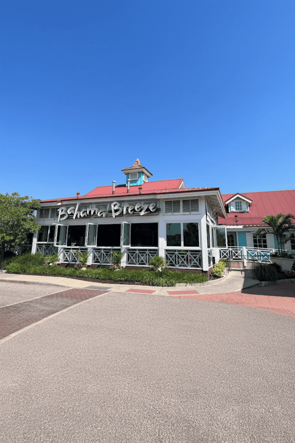 Beachfront restaurant offering outdoor dining with ocean views and tropical ambiance.