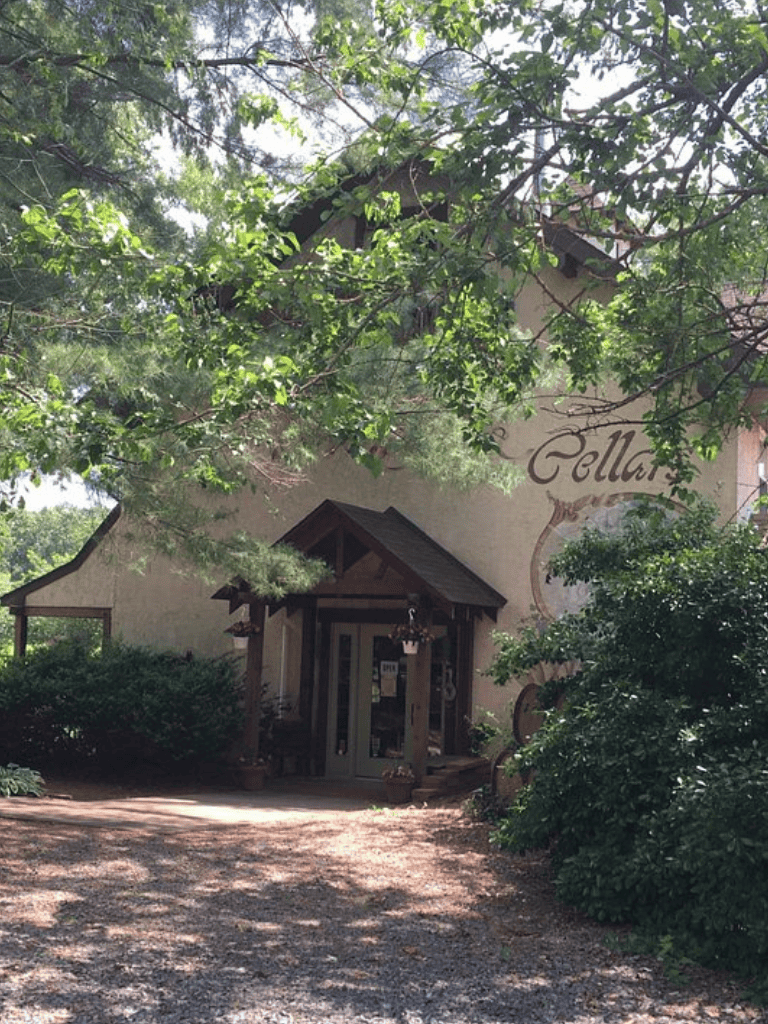 Charming rustic building surrounded by lush greenery at Quest for Directions.