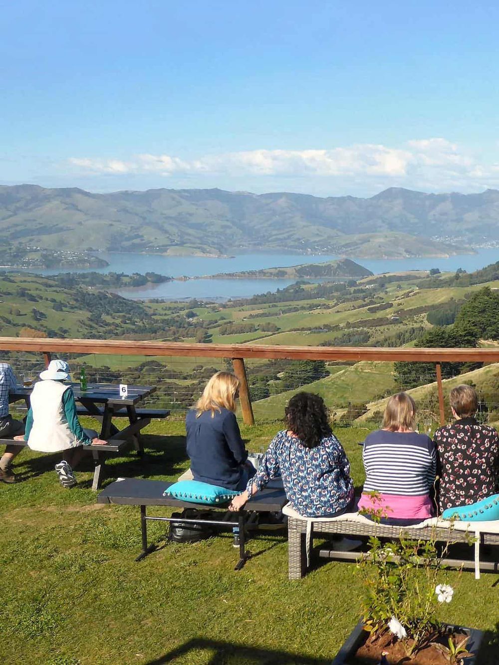 Breathtaking scenic viewpoint overlooking rolling hills and a serene lake, perfect for sightseeing and outdoor adventures.