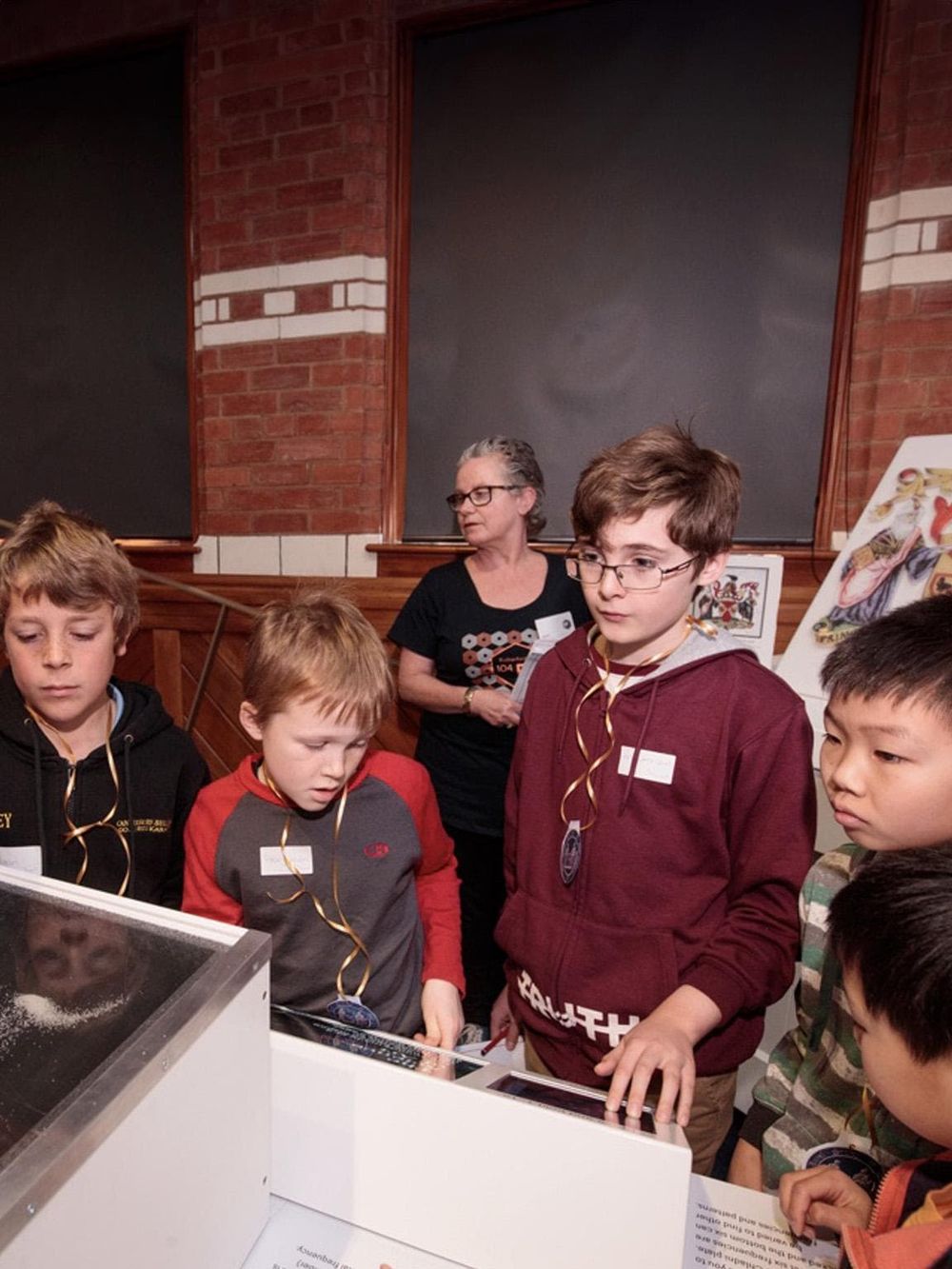 Children participating in an educational science activity or experiment at a Quest for Directions event.