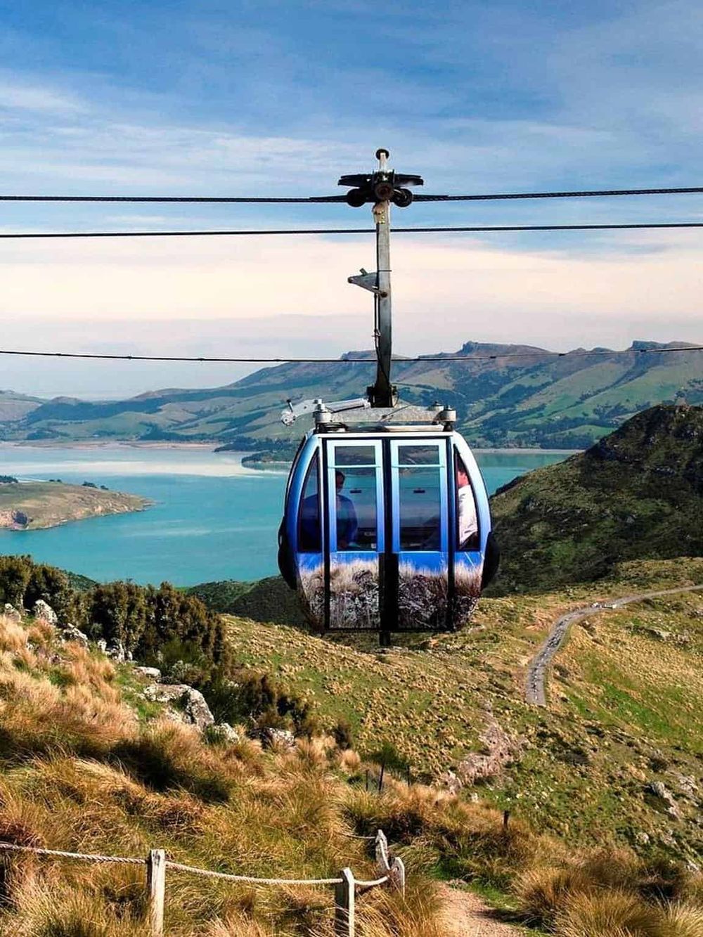 Aerial tramway with scenic mountain and lake views, perfect for adventure and travel enthusiasts.