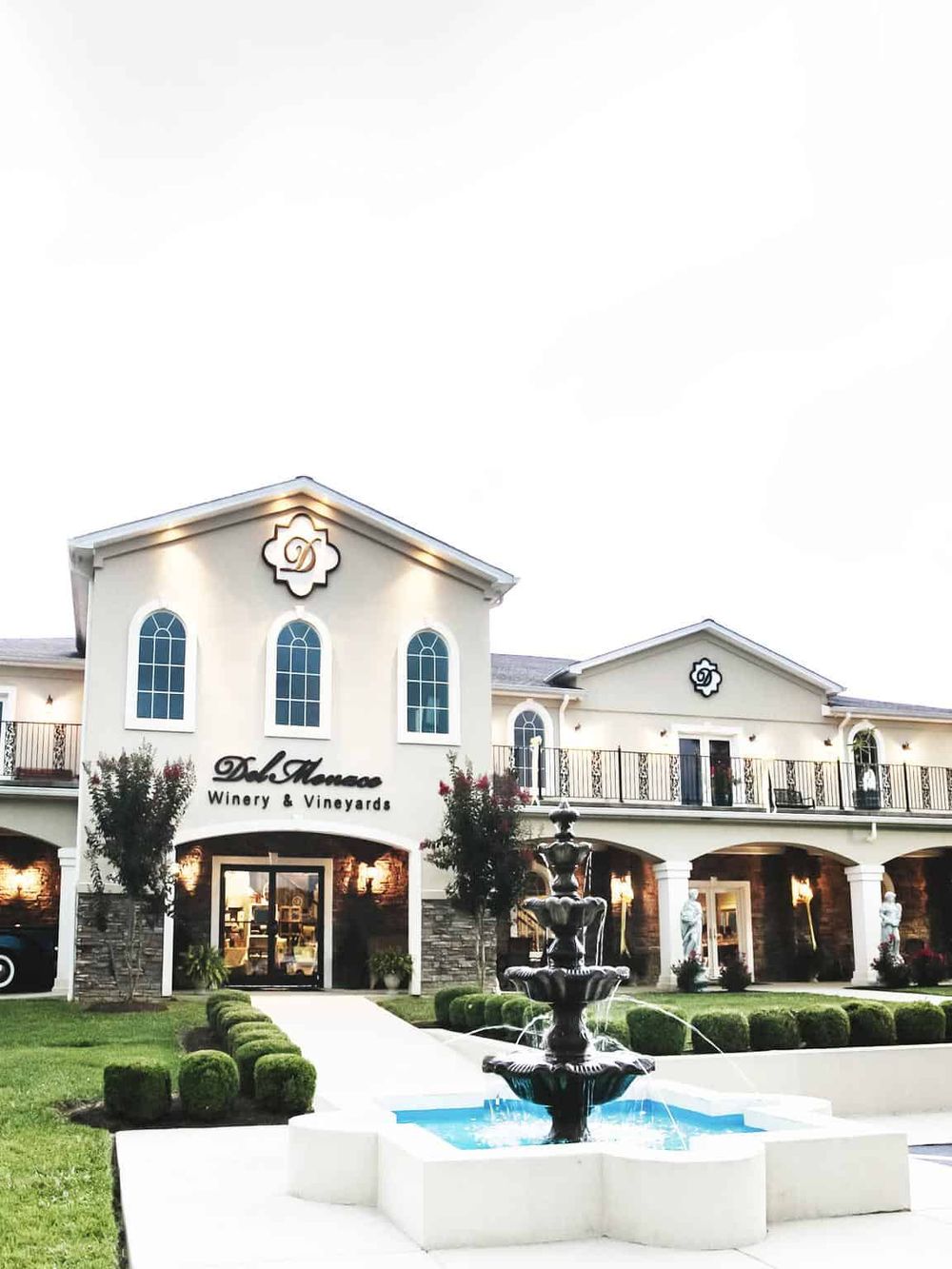 Elegant winery estate with fountain and vineyard views, perfect for wine tasting and vineyard tours.