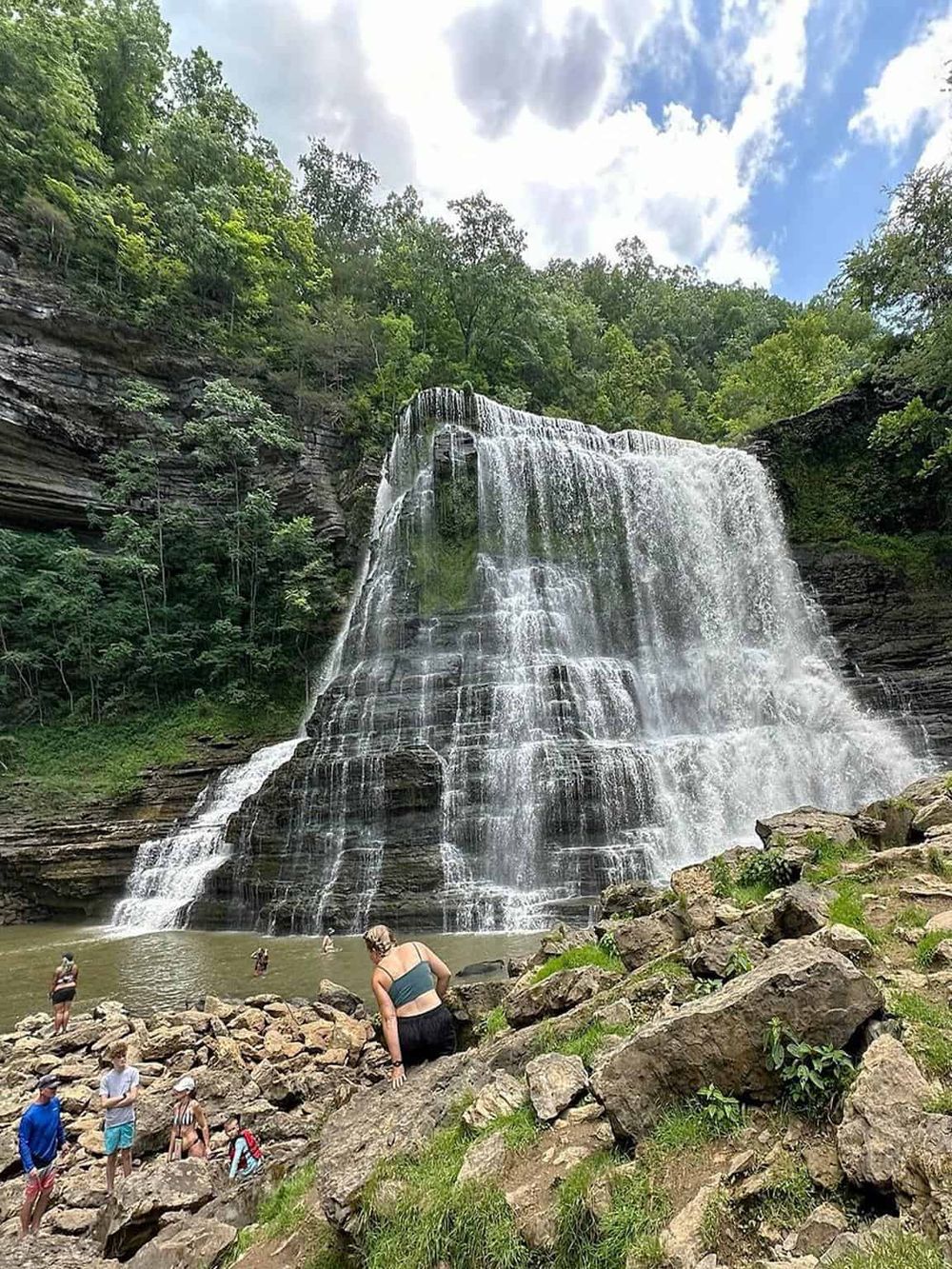 Majestic waterfall in a lush green forest, perfect for nature lovers and adventure seekers. Located near Quest For Directions.