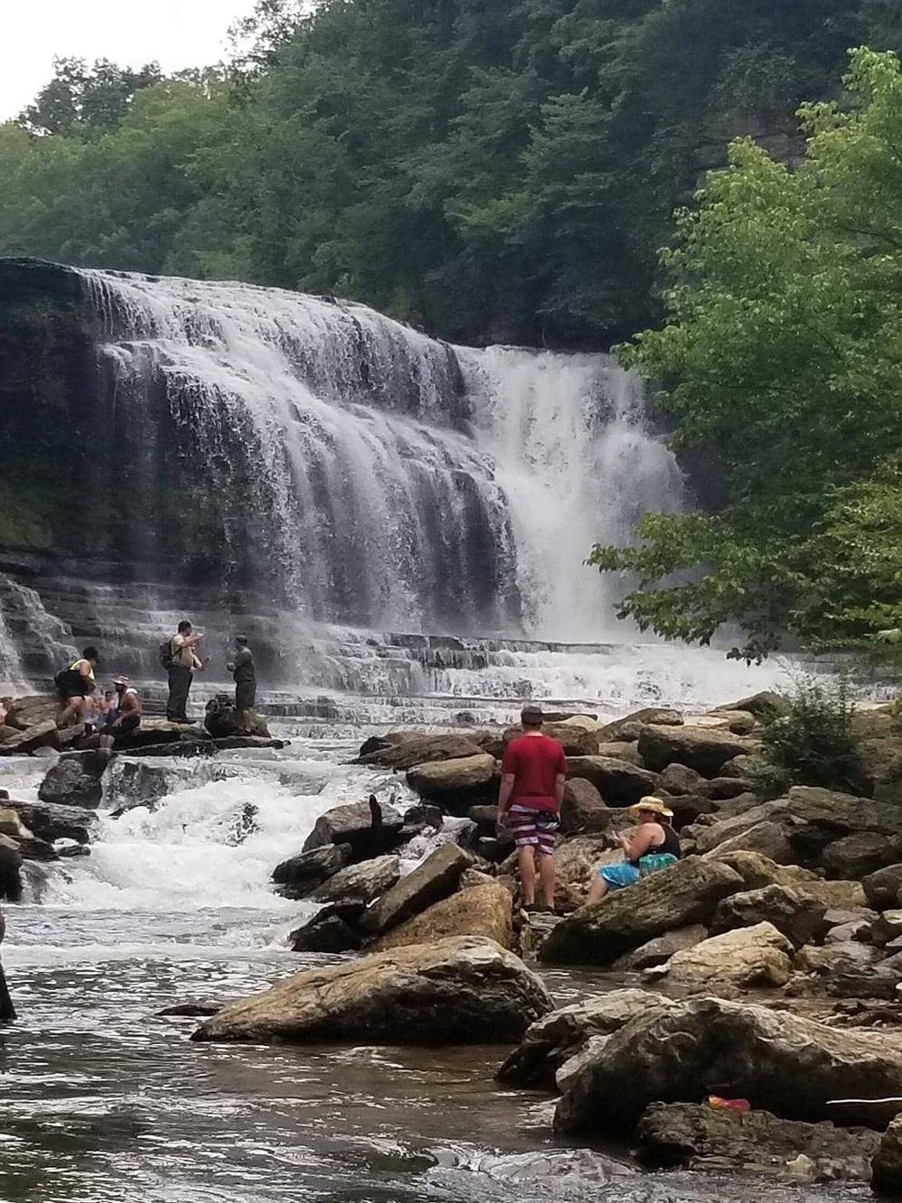Waterfall hiking adventure at QuestForDirections trail in scenic outdoor setting.