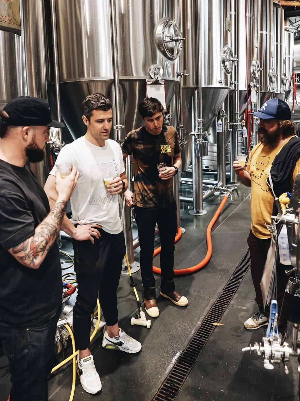 Craft beer tasting at brewery with people enjoying and learning about different brews.