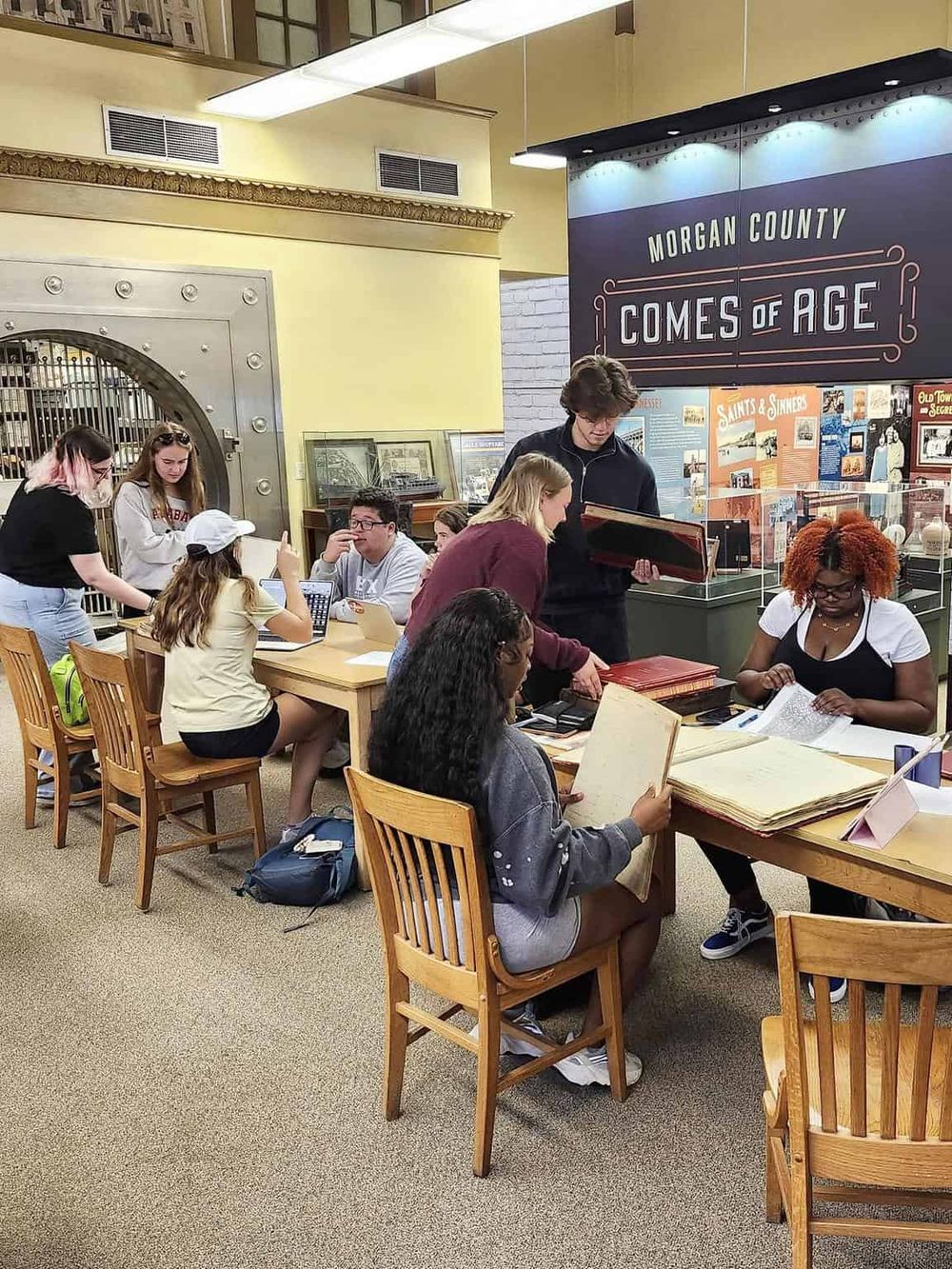 Students researching local history at Morgan County museum, exploring educational exhibits and digital resources.