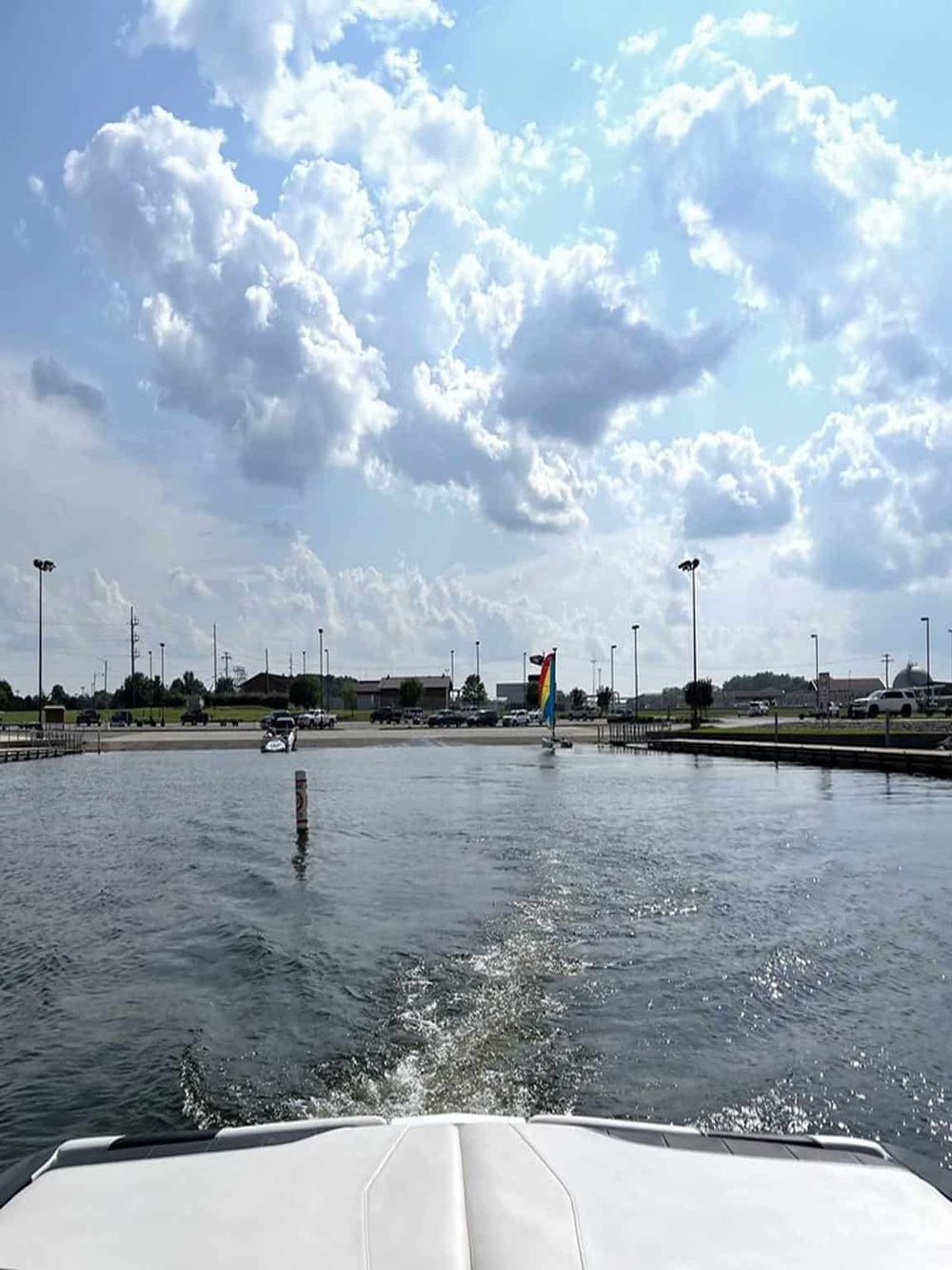 Bright blue sky with clouds over a boat-filled waterway and marina, ideal for exploring water navigation and boating routes.