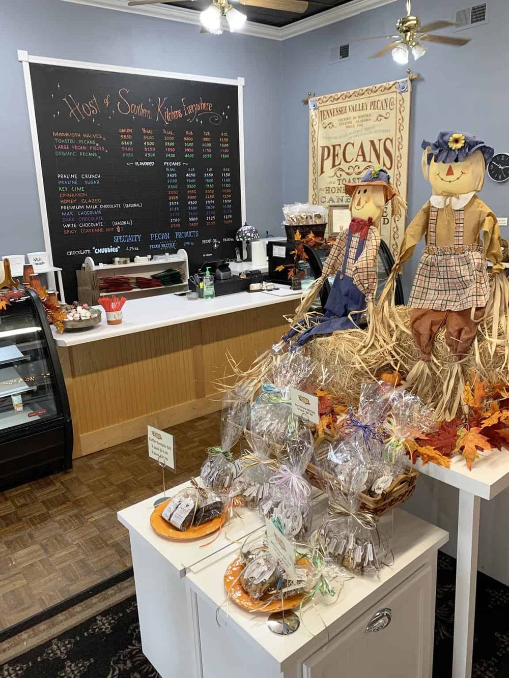 Colorful pecan display with fall harvest decorations at a Southern kitchen-themed store.