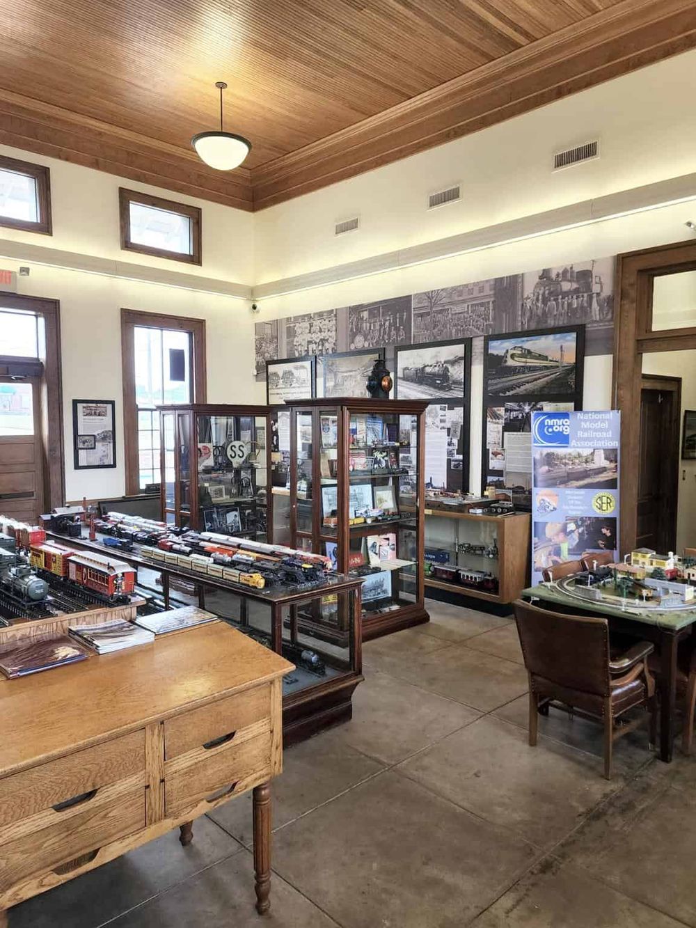 Model train display inside a museum showcasing classic railroad memorabilia, photos, and vintage models.