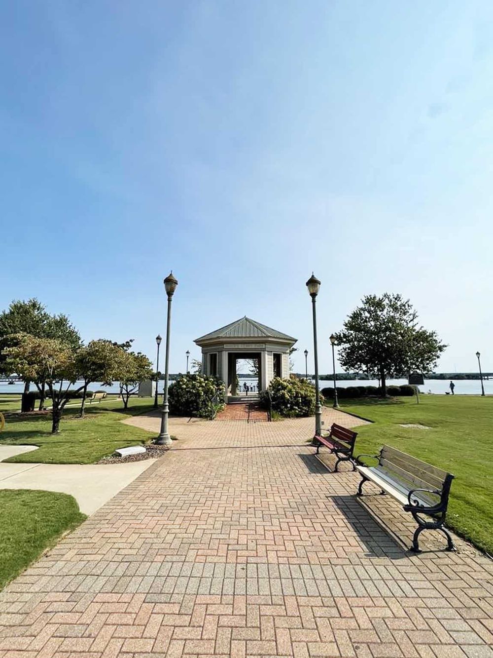 Peaceful waterfront park with a historic gazebo, walking paths, and benches, ideal for relaxation and outdoor activities.