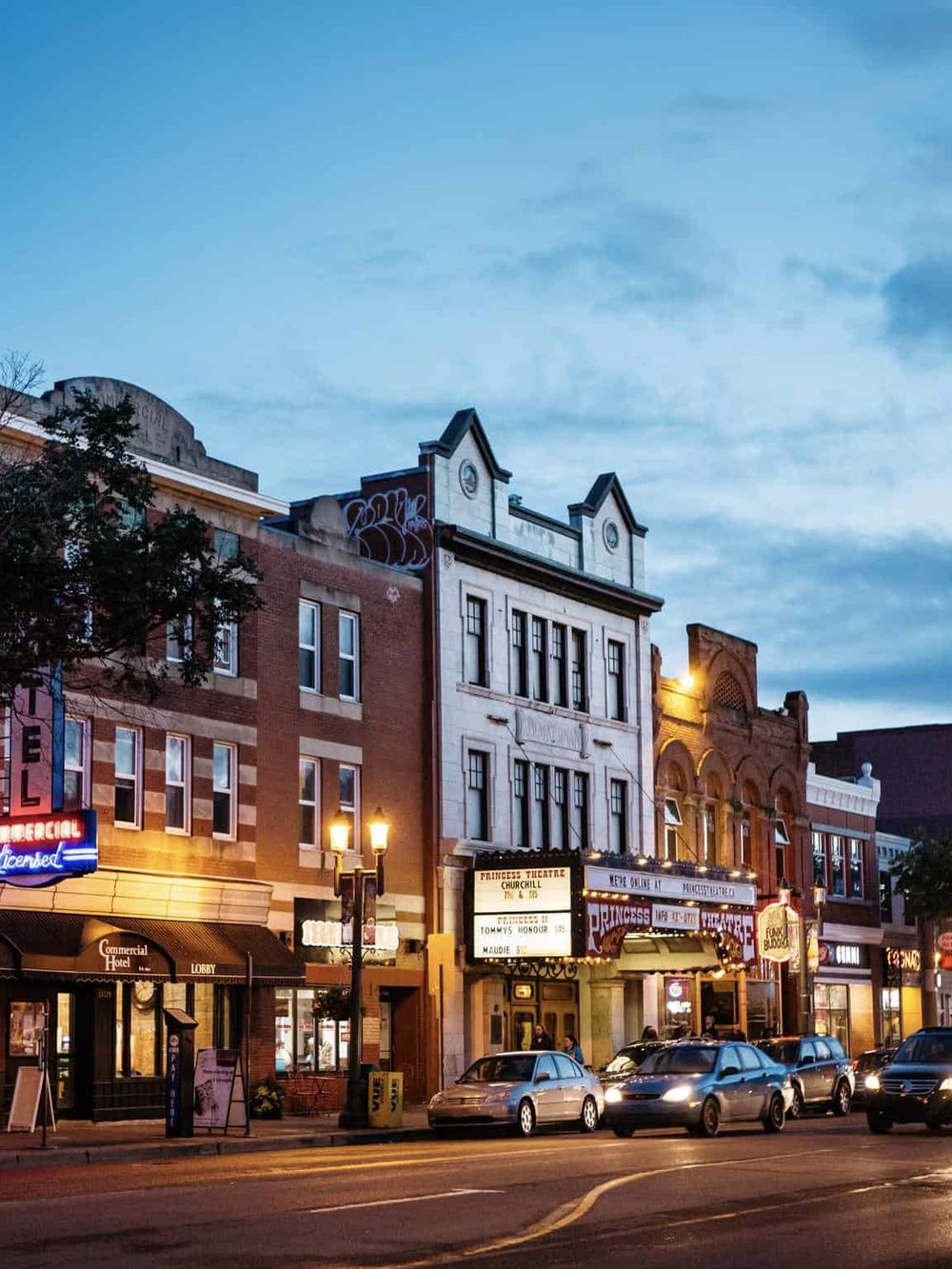 Downtown historic buildings and theaters in QuestForDirections cityscape at dusk.