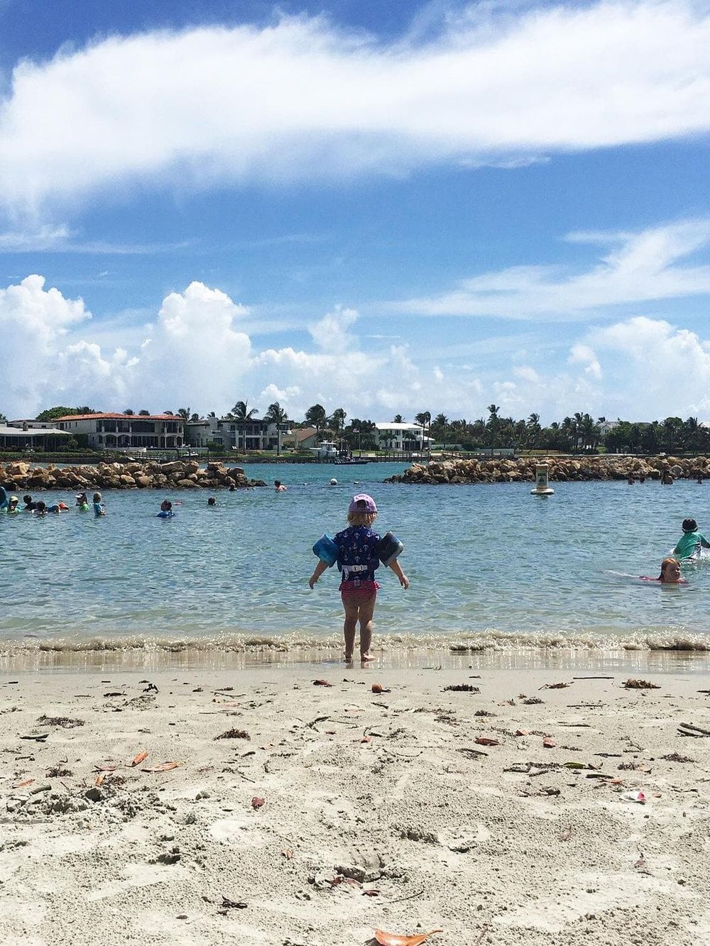 Child at the beach, family vacation, coastal scenery, water safety, seaside travel, QuestForDirections.