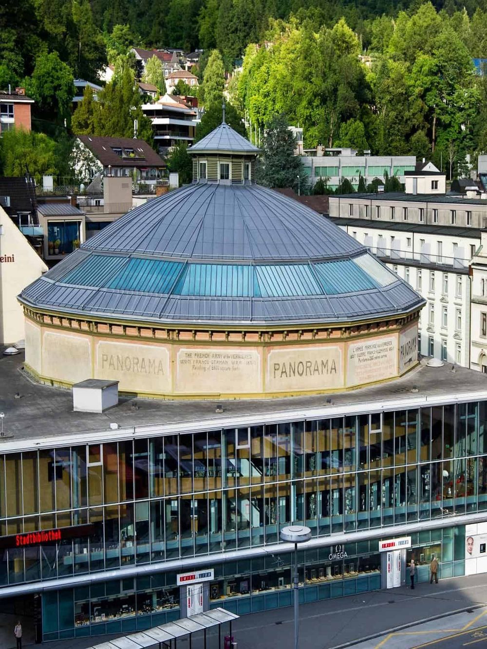 Modern architectural building with glass facade in an urban setting, emphasizing city navigation and destination guidance.