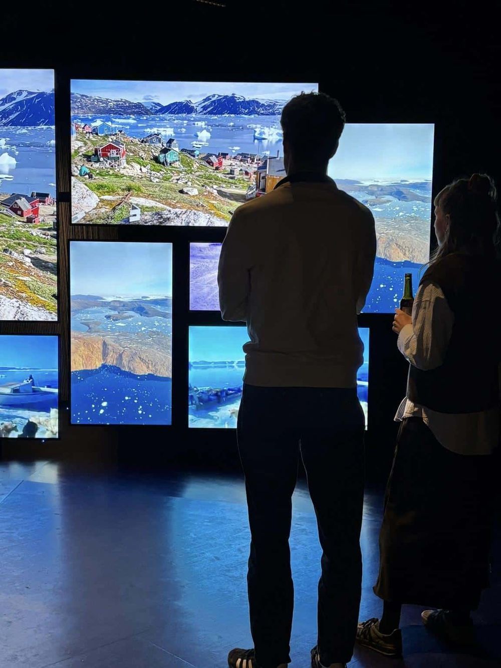 Vibrant Arctic scenery displayed on multiple screens at Quest for Directions exhibit.