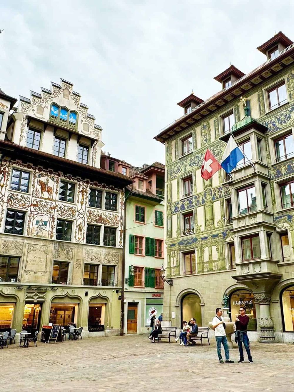 Colorful European buildings in Lucerne, Switzerland, showcasing beautiful architecture and city life.