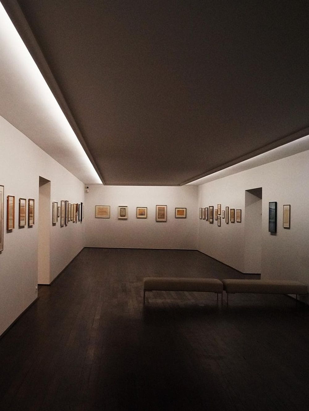 Art gallery interior showcasing framed artwork and modern decor for cultural exploration.