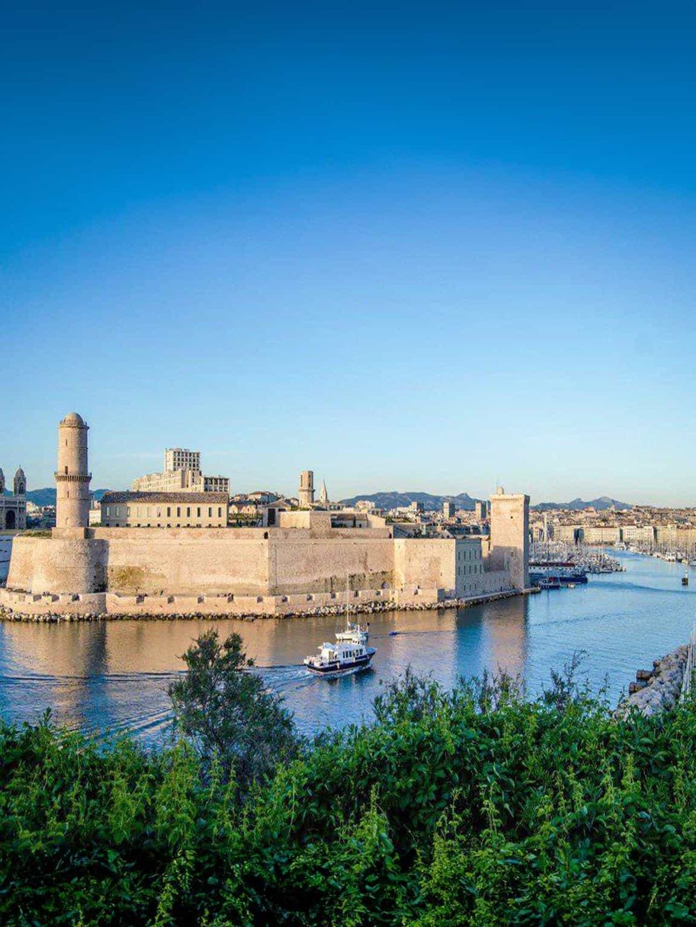 Medieval fortress and harbor in historic Marseille, France, showcasing ancient architecture and vibrant waterfront.