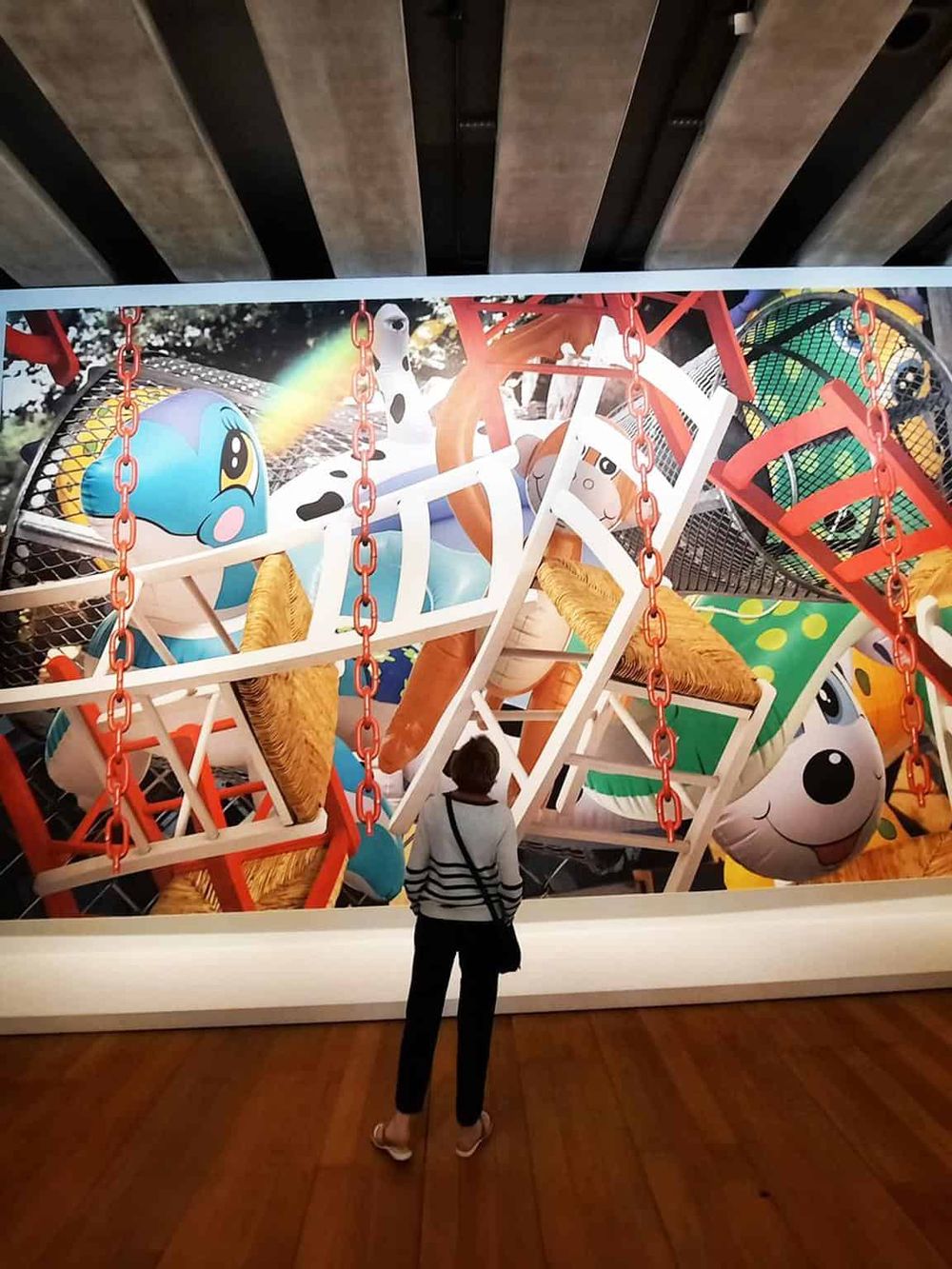 Colorful amusement park ride with cartoon character decorations, viewed from ground level.
