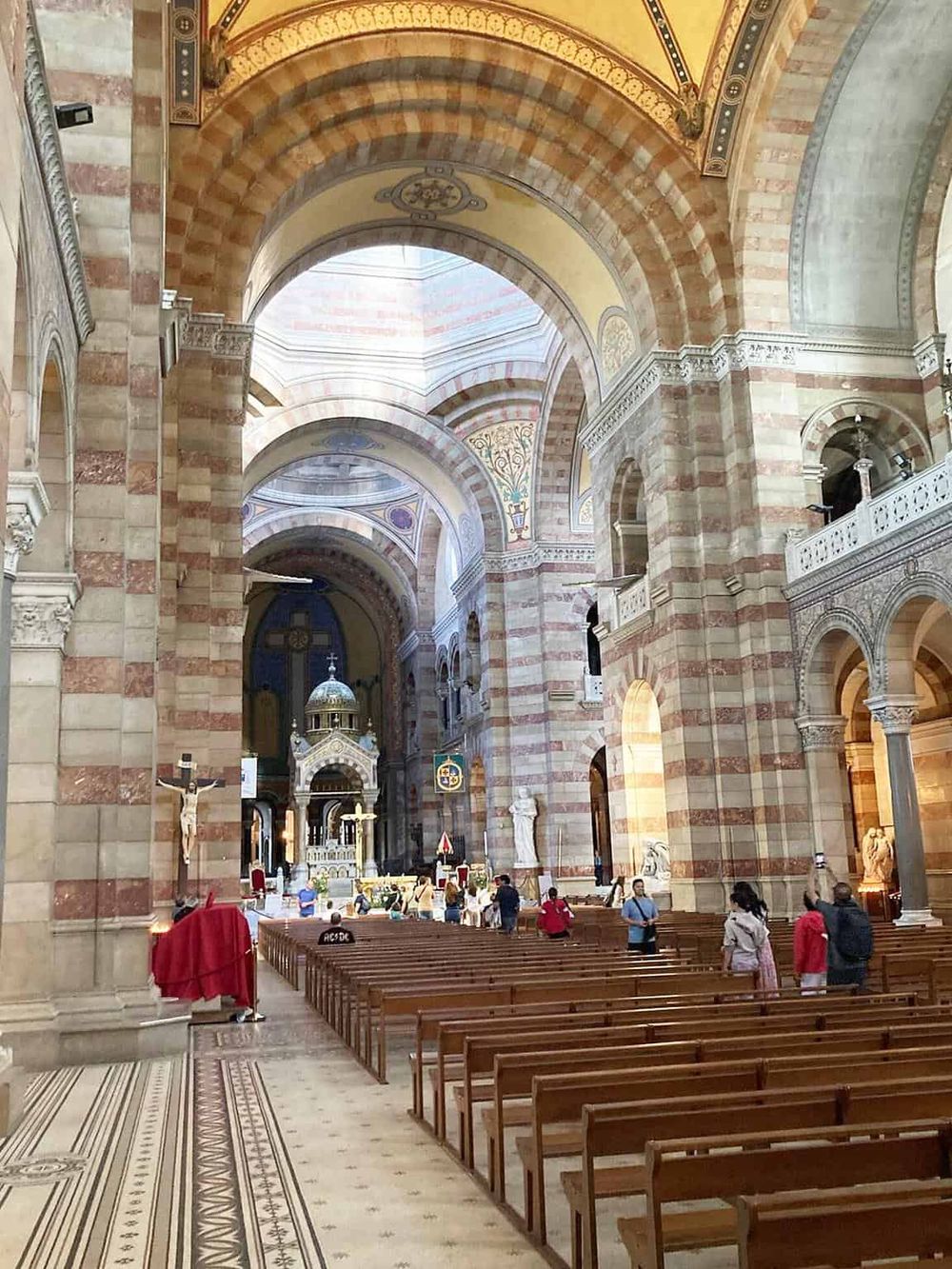 Majestic cathedral interior with ornate arches, statues, and religious symbols, showcasing elegant architecture and spiritual ambiance.